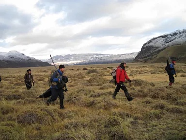 Research team hiking through Patagonian grassland